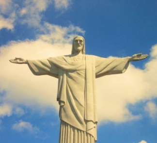 Picture of Christ The Redeemer statue against a blue sky with white clouds